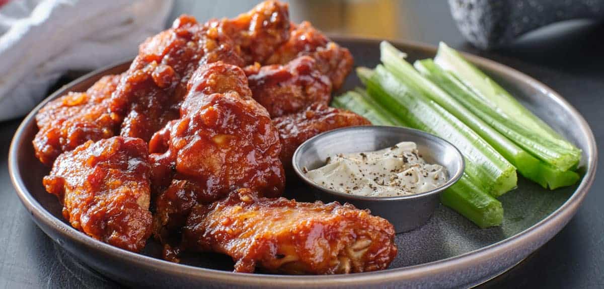 boneless-chicken-wings-covered-in-honey-garlic-bbq-sauce-with-ranch-and-celery
