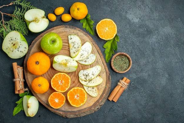 top-view-cut-apples-mandarines-rustic-serving-board-